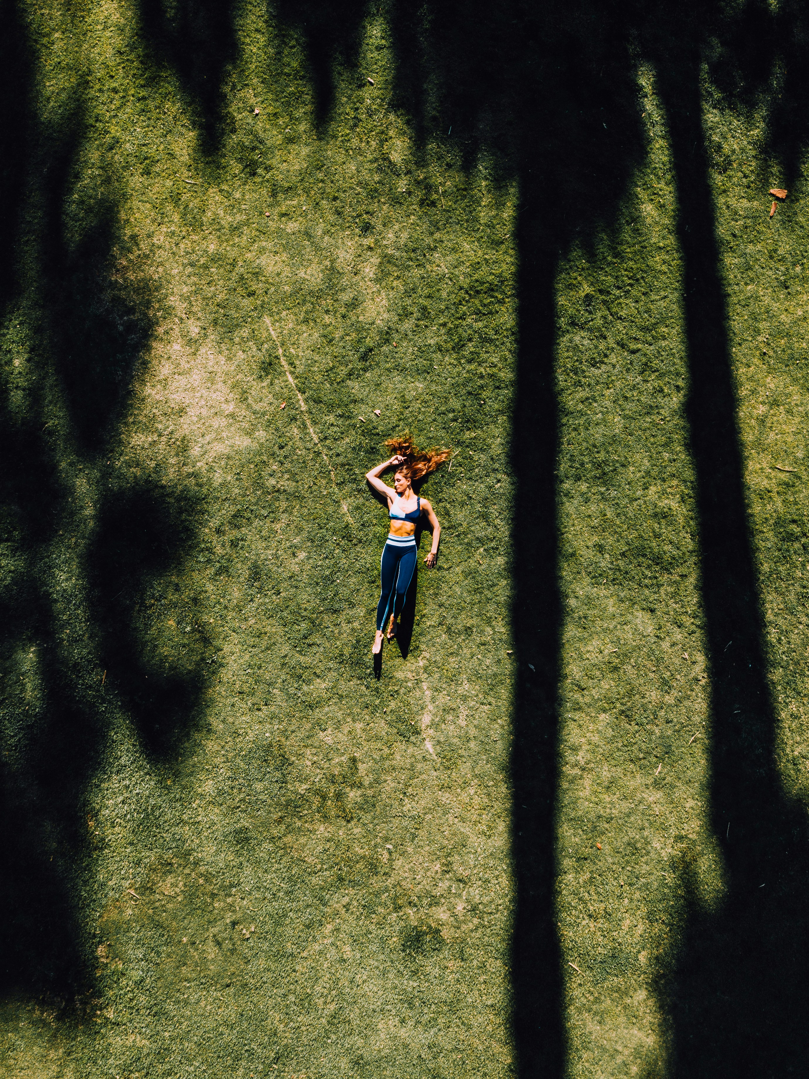 A woman resting on the grass in dappled shade